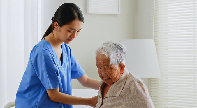 caretaker assisting senior patient
